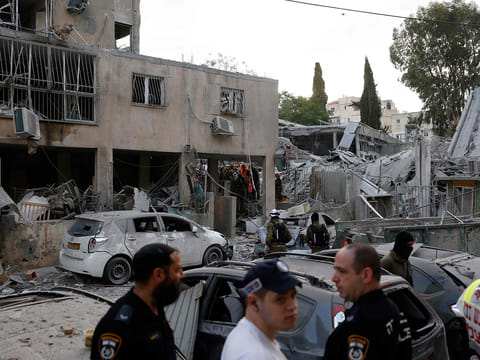 Rescuers work near a damaged building following a strike by an Iranian missile in the Israeli city of Bnei Brak, east of Tel Aviv, on June 16, 2025. 