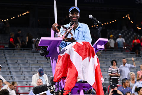 Victoria Mboko of Canada poses with a Canadian flag and the trophy at the umpire's chair following her victory against Naomi Osaka of Japanin Montreal, Quebec, Canada.