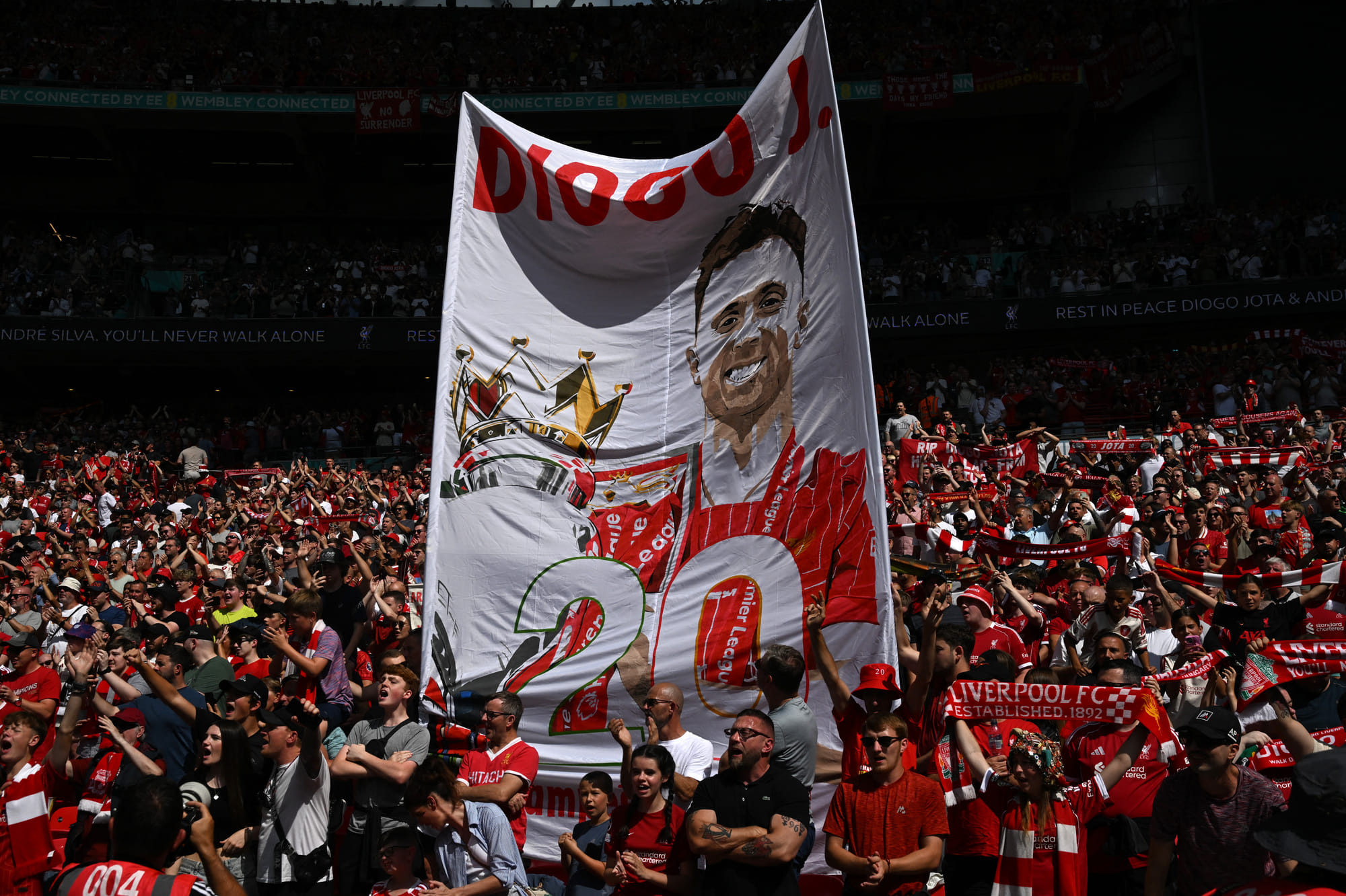 Liverpool fans display a banner to pay tribute to Liverpool's Portuguese forward Diogo Jota ahead of the English FA Community Shield match against Crystal Palace.