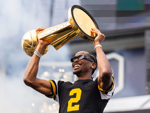 Oklahoma City Thunder's Shai Gilgeous-Alexander holds up the Larry O'Brien Trophy during a ceremony honoring the NBA basketball champion.