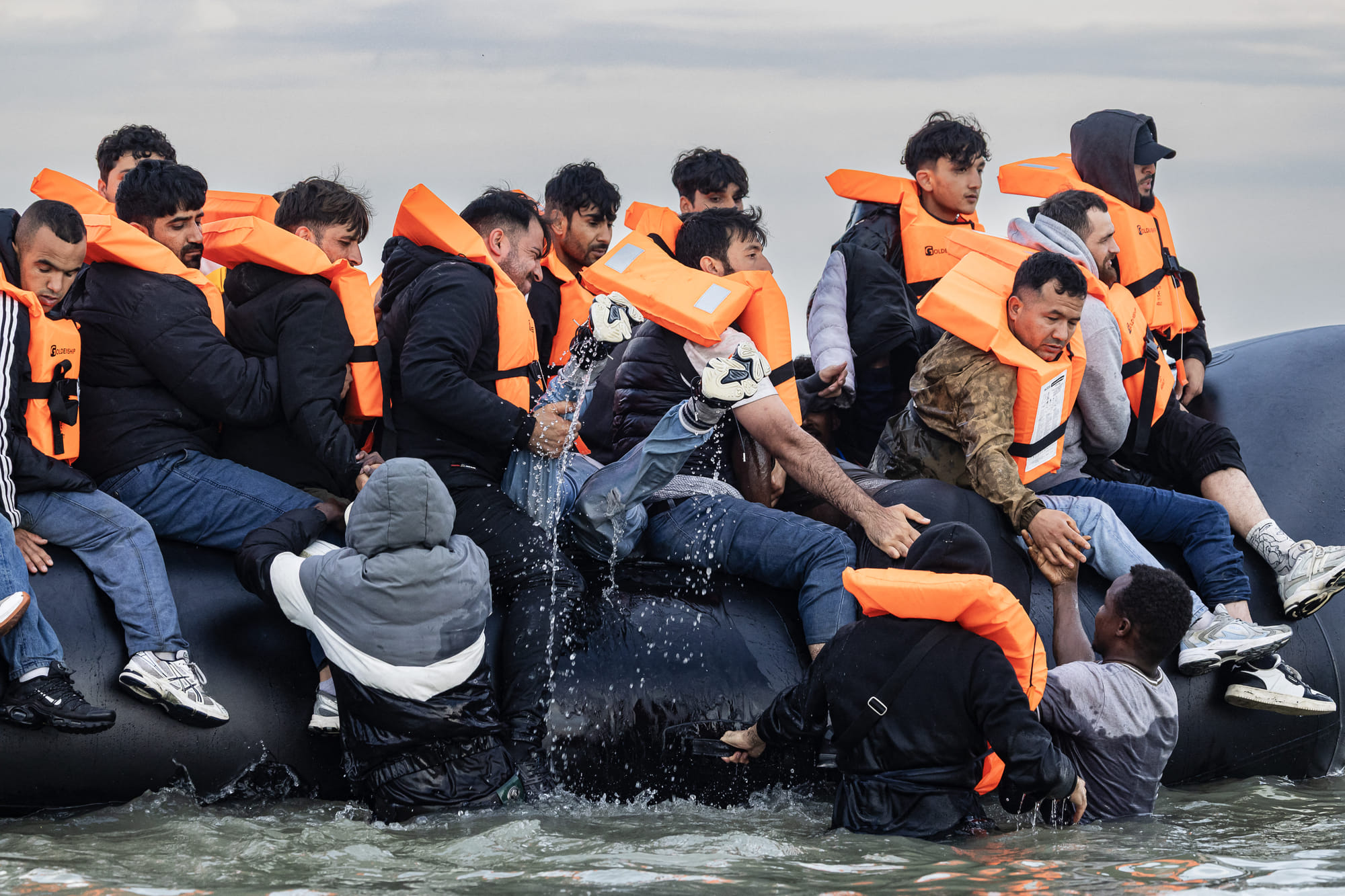 Migrants try to board a smuggler's boat in an attempt to cross the English Channel off the beach of Gravelines, northern France. In a dramatic scene unfolding at dawn on August 12, 2025, dozens of migrants sprinted across Gravelines beach in north of France in a desperate attempt to board a smuggler’s boat bound for the UK.