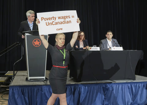 Air Canada executives are interrupted by Air Canada flight attendants during a news conference as a possible strike looms, in Toronto, on Thursday, Aug. 14, 2025.