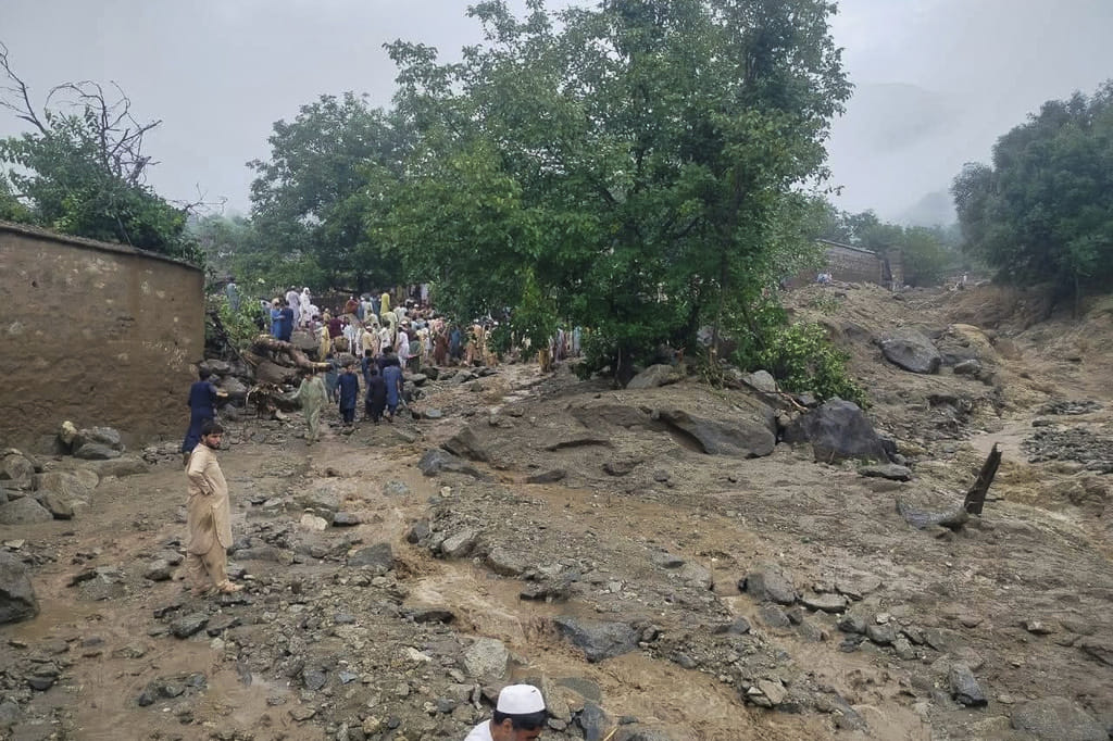 Rescue workers and local residents gather at the site of a massive cloudburst that led to flash flooding in Salarzai, Pakistan. (Rescue 1122 Emergency Department via AP)