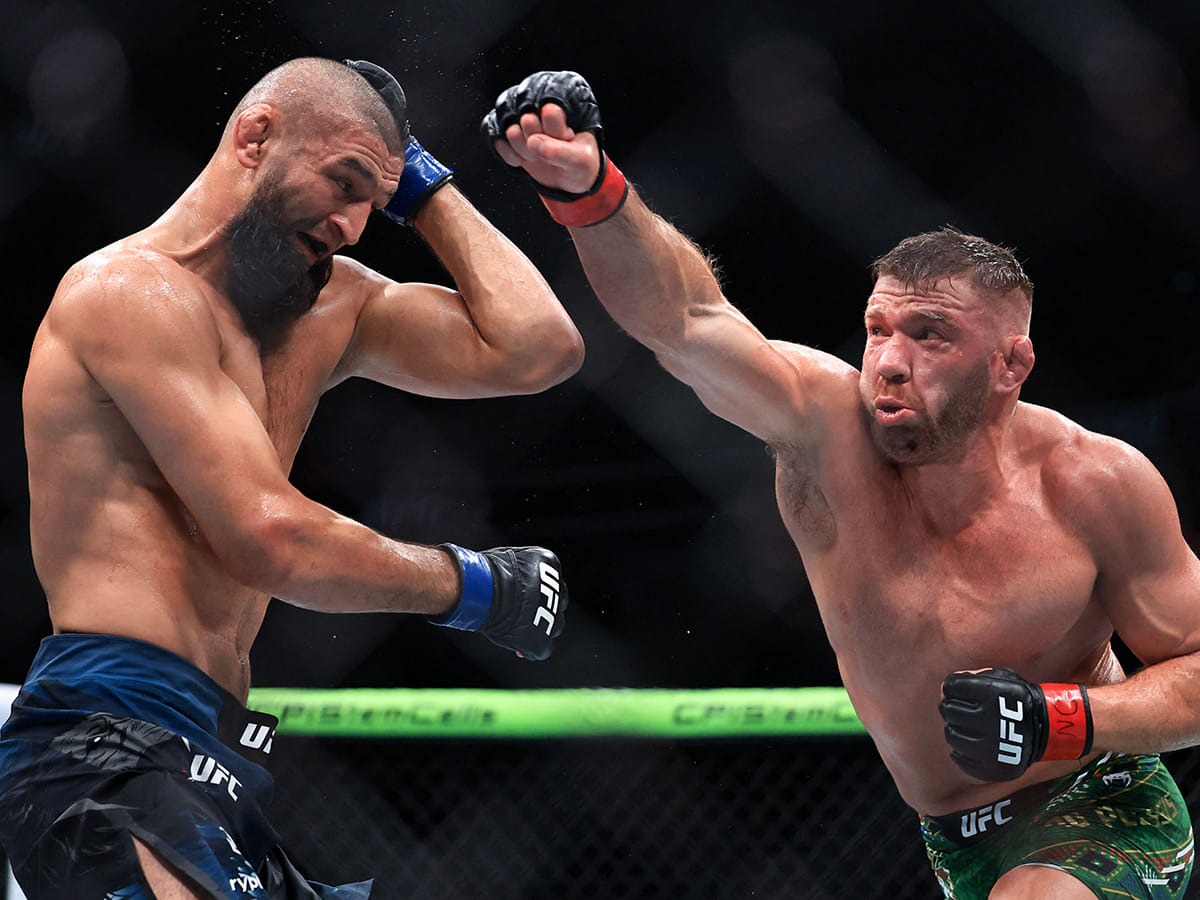 Dricus du Plessis of South Africa strikes Khamzat Chimaev of the United Arab Emirates during their middleweight title bout in UFC 319 at the United Center on August 16, 2025 in Chicago, Illinois.