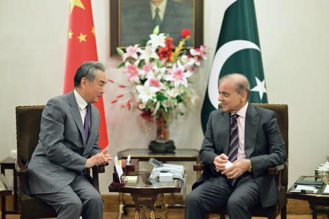 This handout photograph taken and released by Pakistan's Prime Minister Office on August 21, 2025 shows Pakistan's Prime Minister Shehbaz Sharif (R) speaking with Chinese Foreign Minister Wang Yi at the Prime Minister House in Islamabad.