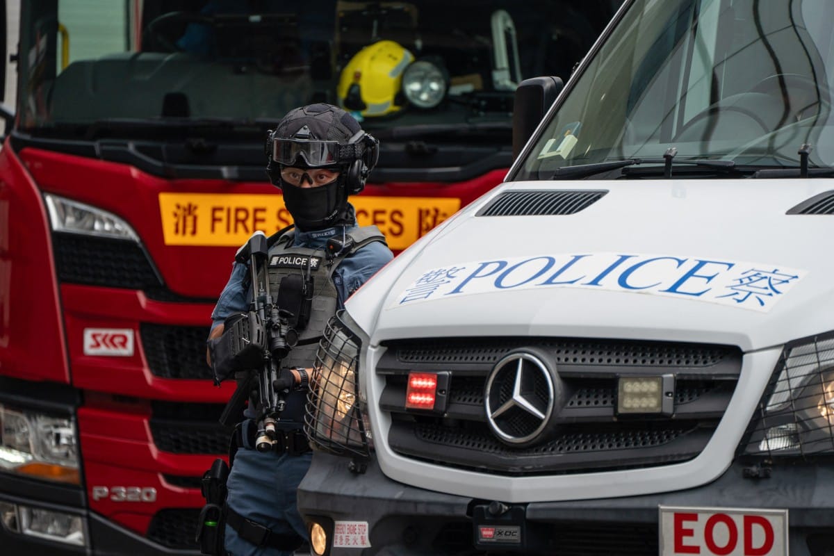 A Hong Police police officer stands guard next to a police van during an exercise in Hong Kong. File photo taken on August 28, 2025.