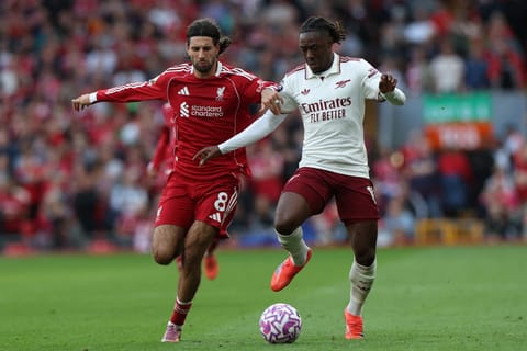 Liverpool's Dominik Szoboszlai (left) shoots to score his sides first goal during the English Premier League match against Arsenal in Liverpool, England, on August 31, 2025.