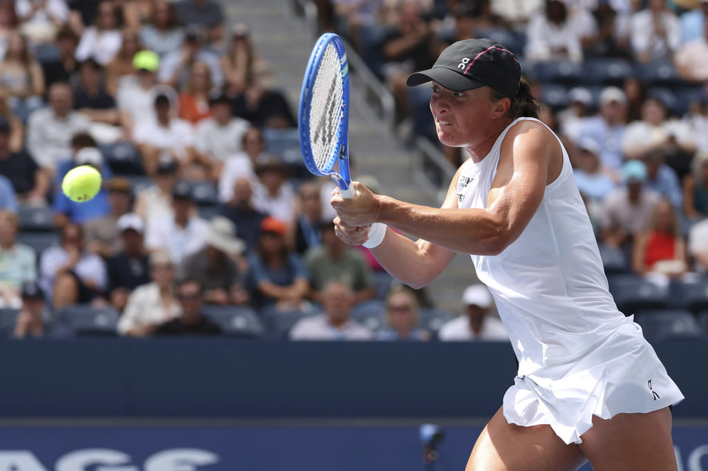 Iga Swiatek, of Poland, returns a shot against Ekaterina Alexandrova, of Russia, during the fourth round of the US Open tennis championships, Monday, Sept. 1, 2025, in New York. 