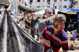 People inspect damages at a tent encampment that was sheltering displaced people, after it was hit by Israeli bombardment, near Shifa Hospital in Gaza City. File photo taken on September 4, 2025.