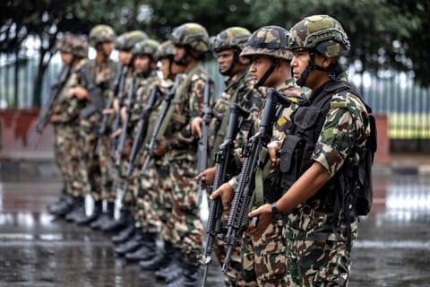 Army personnel stand guard along a street during a curfew imposed to restore law and order in Kathmandu on September 11, 2025.