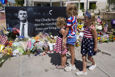 Sisters Clara Hetland, 4, left, Haddie Hetland, center, 9, and Audra Hetland 6, of Surprise, Ariz., spend time at a makeshift memorial set up at Turning Point USA headquarters after the shooting death at a Utah college on Wednesday of Charlie Kirk, the co-founder and CEO of the organisation, Thursday, Sept. 11, 2025, in Phoenix.
