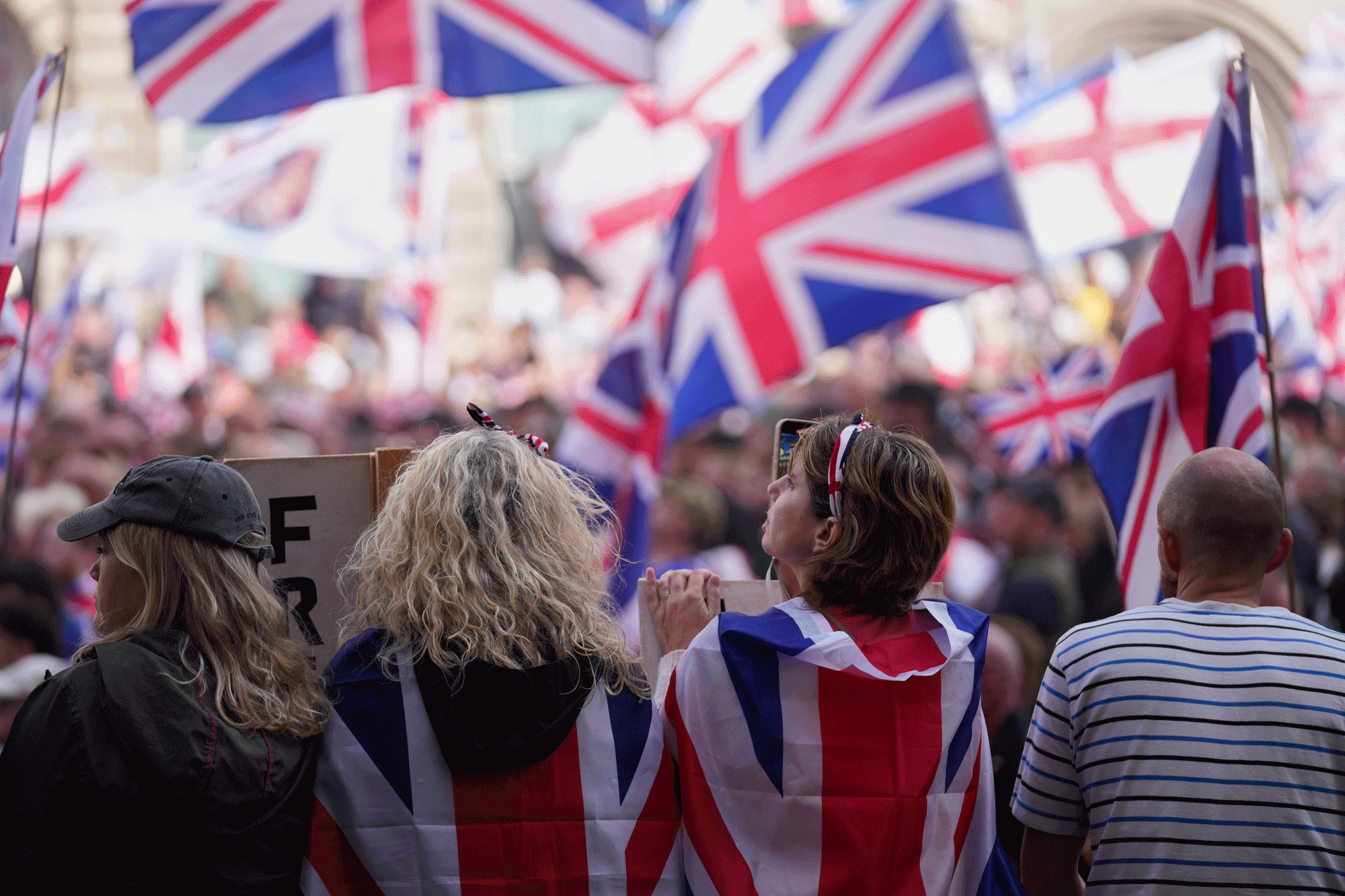 People demonstrate during the Tommy Robinson-led Unite the Kingdom march and rally, in London on September 13, 2025.  