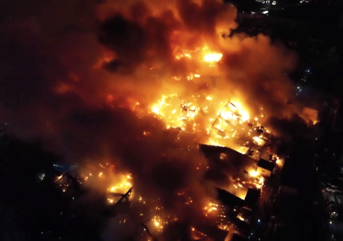 The blaze, which started around 8:28pm on Saturday in Buildings 7 and 8 of "Happyland" rapidly spread through dozens of shanty homes built from highly flammable light materials like plywood and corrugated metal.