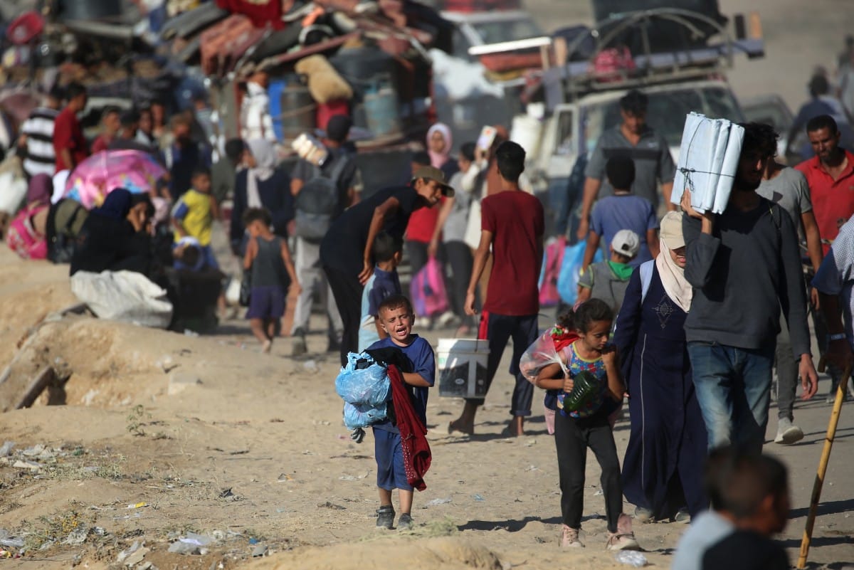 Displaced Palestinians move with their belongings southwards on a road in the Nuseirat refugee camp area in the central Gaza Strip following renewed Israeli evacuation orders for Gaza City.