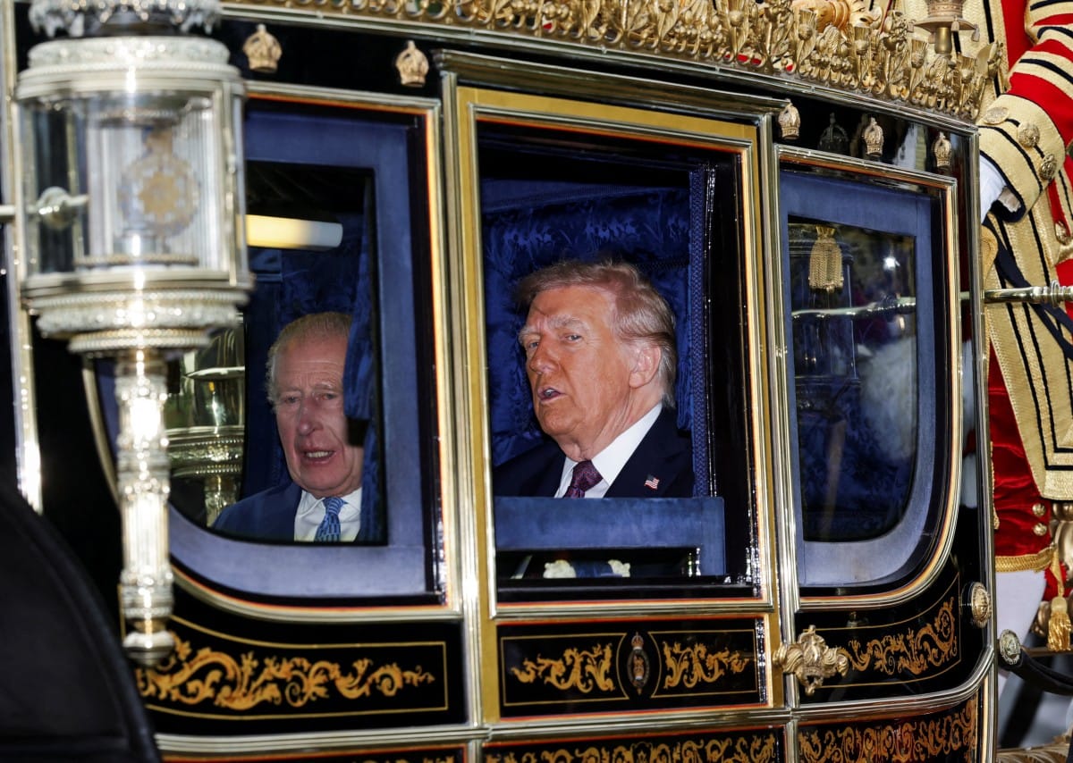 Britain's King Charles III and US President Donald Trump travel in The Irish State Coach during a horse-drawn procession towards Windsor Castle, in Windsor, on September 17, 2025, during a second State Visit.