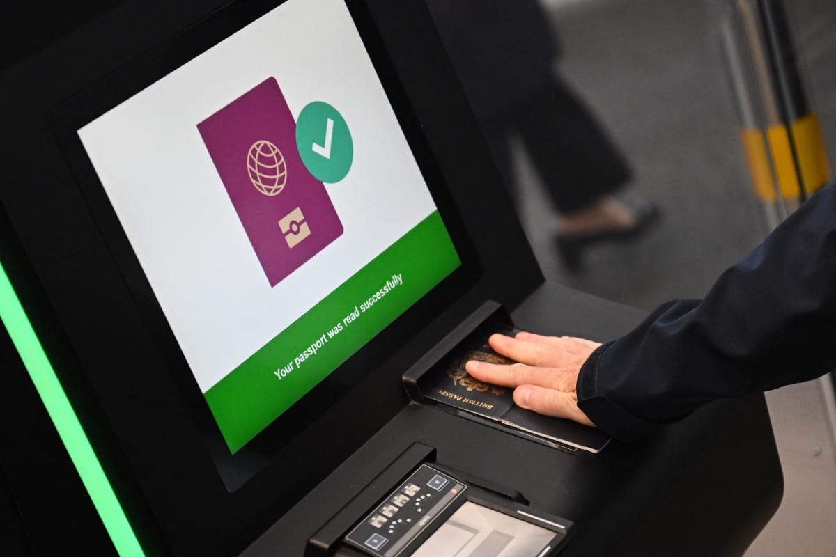 A person as their passport scanned whilst using an Automated European Union Entry/Exit System (EES) kiosk during a press preview on the rollout of the EU's new Entry-Exit System (EES) at Eurotunnel, south east England on September 23, 2025.