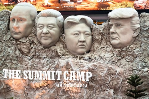 A parody Mount Rushmore sculpture depicts the faces of Russia's President Vladimir Putin (L), China's President Xi Jinping (2nd L), North Korea's leader Kim Jong-un (2nd R), and US President Donald Trump (R) at "The Summit Camp" camping and outdoors experience at a shopping mall in Bangkok.
