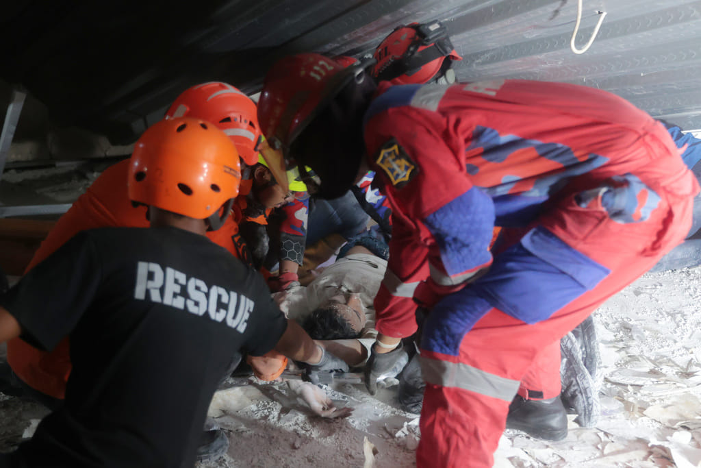 Searchers in Indonesia raced Tuesday to rescue dozens of people still believed trapped.