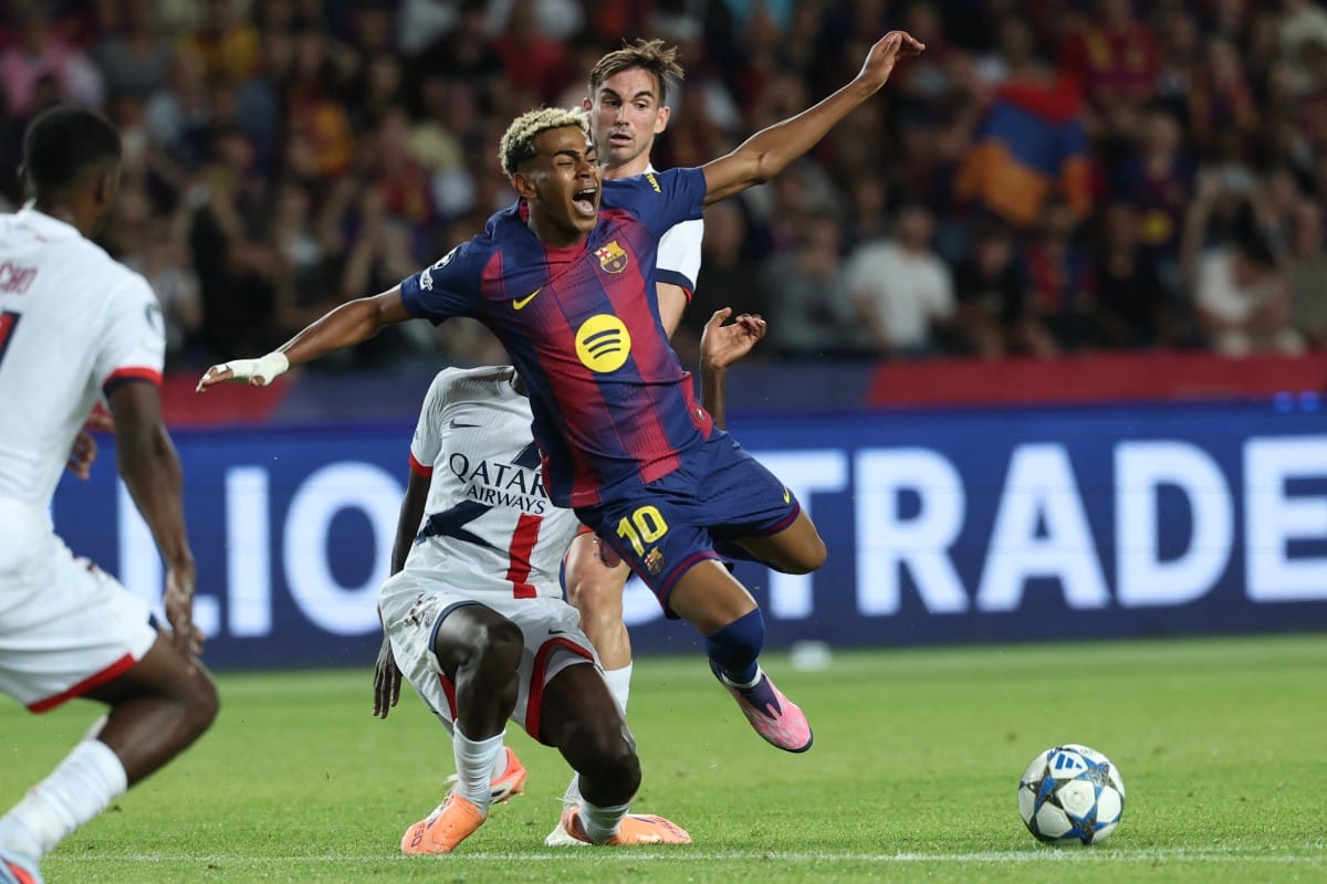 Barcelona's Spanish forward #10 Lamine Yamal (C) reacts as he is fouled by Paris Saint-Germain's Portuguese defender #25 Nuno Mendes during the UEFA Champions League league phase day 2 football match between FC Barcelona and Paris Saint-Germain (PSG) at the Estadi Olimpic Lluis Companys in Barcelona, on October 1, 2025.