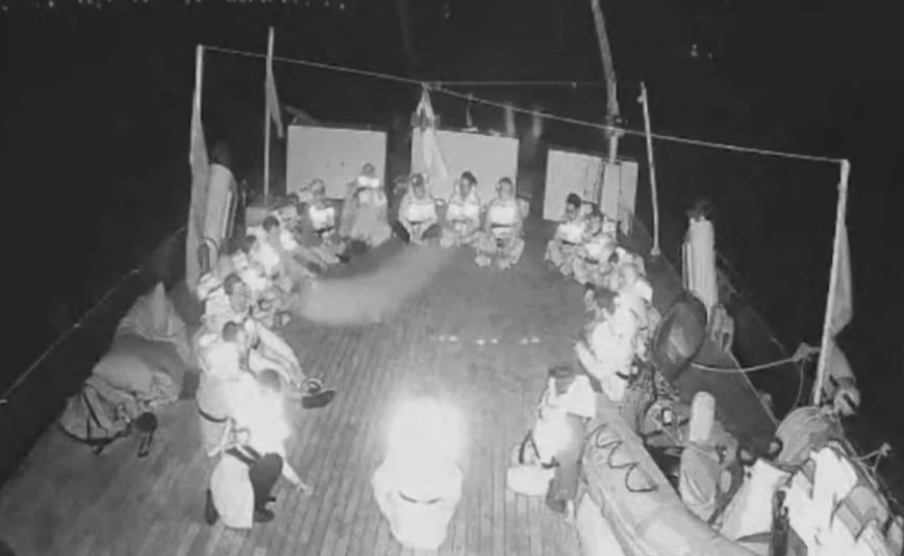 In this handout screenshot taken from live video footage, crew members can be seen sitting in a circle aboard the Gaza-bound "Alma" vessel on Wednesday. 
