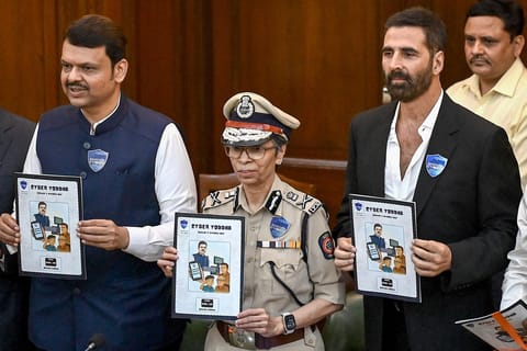 Devendra Fadnavis (L), Chief Minister of Maharashtra state, Rashmi Shukla (C), Director General of Police (DGP) of Maharashtra and Bollywood actor Akshay Kumar attend the inauguration event of Cyber Awareness Month 2025 at State Police Headquarters in Mumbai on October 3, 2025.