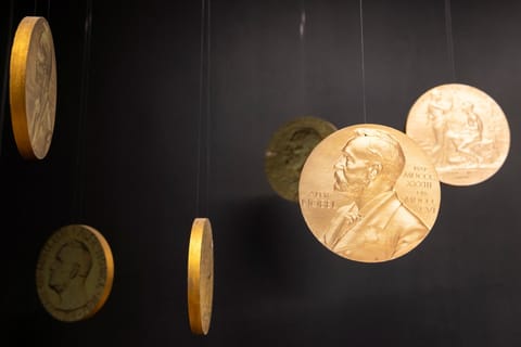 In this file photo taken on December 9, 2021 replicas of the official Nobel Peace Prize gold medal are seen at the exhibition at the Nobel Peace Center in Oslo.