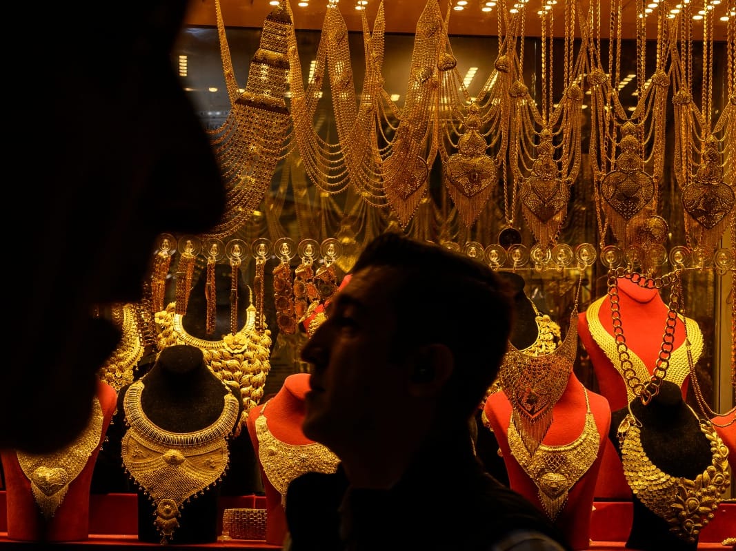People walk past a gold shop at the Grand Baazar in Istanbul, on October 10, 2025.