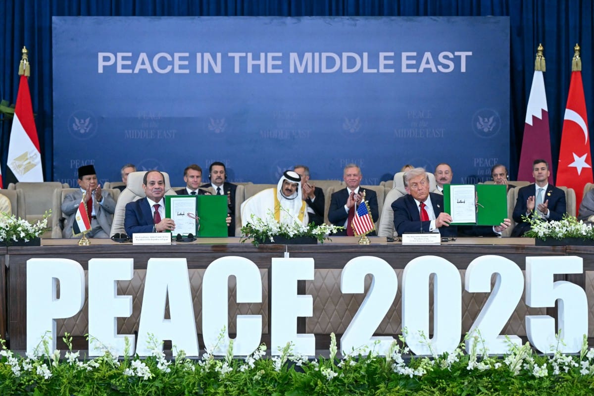 Trump (right) and Egypt's President Abdul Fattah Al Sissi show signed documents during a summit on Gaza in Sharm Al Sheikh on October 13, 2025.