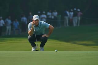 Rory McIlroy of Northern Ireland checks before taking a shot during the DP World Tour Championship golf tournament in New Delhi, India, Thursday, Oct. 16, 2025..