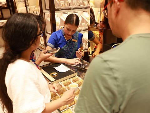 Sales staff attend to a steady stream of buyers taking advantage of festive offers across Dubai’s gold shops.