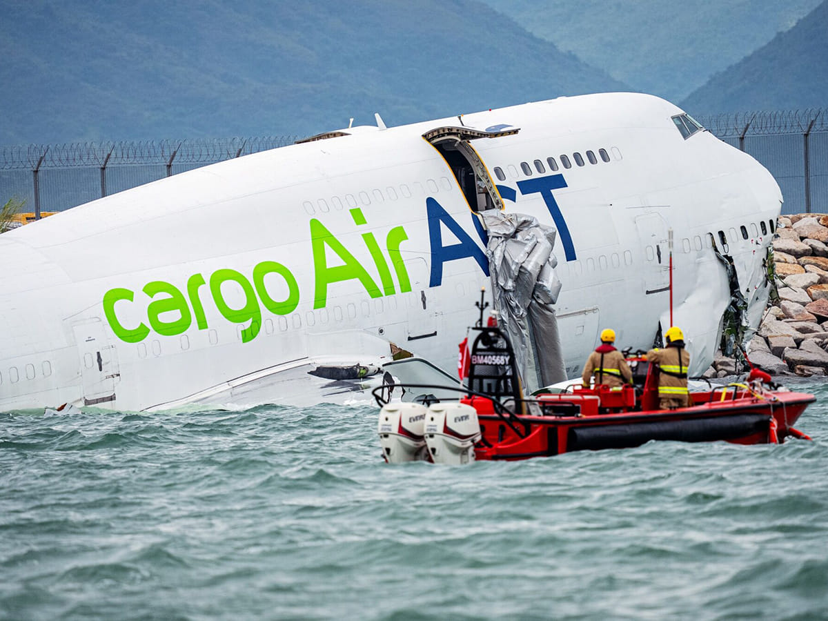 Rescue workers at the wreckage of an AirACT cargo aircraft, a Boeing 747, near the runway at Hong Kong International Airport in Hong Kong, China, on Monday, October 20, 2025.