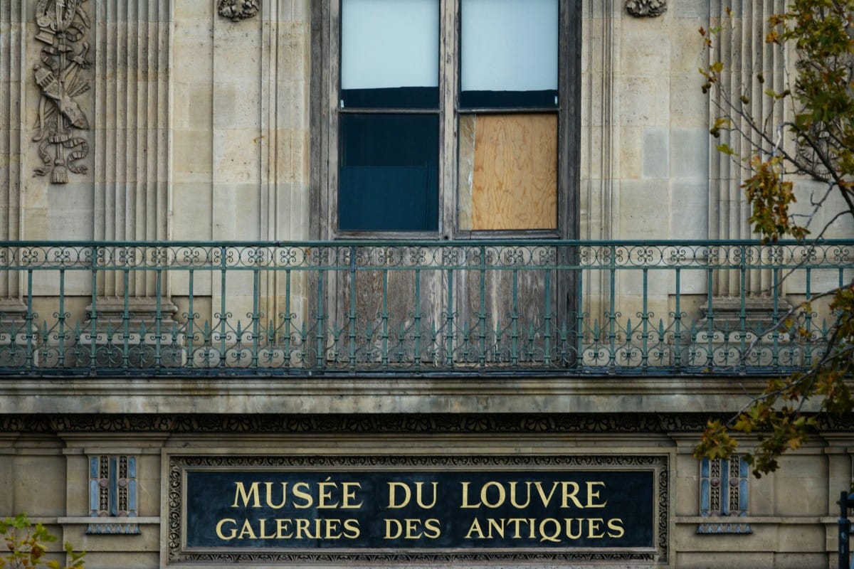 The window of the Louvre Museum is seen with the glasses covered after the thieves broke them to get in and steal priceless jewels.