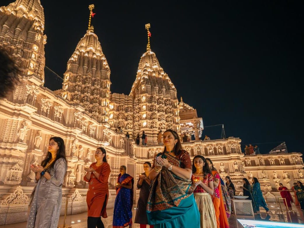 Women take part in the Diwali prayers at the BAPS Hindu Mandir in Abu Dhabi on Monday night. 