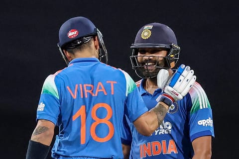 India's Rohit Sharma (R) celebrates with his teammate Virat Kohli after scoring a century (100 runs) during the third one-day international (ODI) men's cricket match between Australia and India at the Sydney Cricket Ground in Sydney on October 25, 2025.