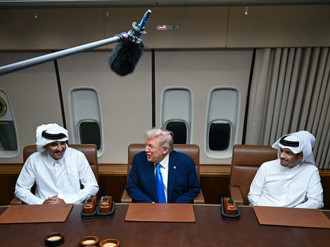US President Donald Trump meets Qatar’s Emir Sheikh Tamim bin Hamad Al Thani (L) and Prime Minister and Foreign Minister Sheikh Mohammed bin Abdulrahman bin Jassim Al Thani (R) aboard Air Force One in Doha on October 25, 2025, as he makes a refuelling stop on his way to Malaysia for the ASEAN summit. 