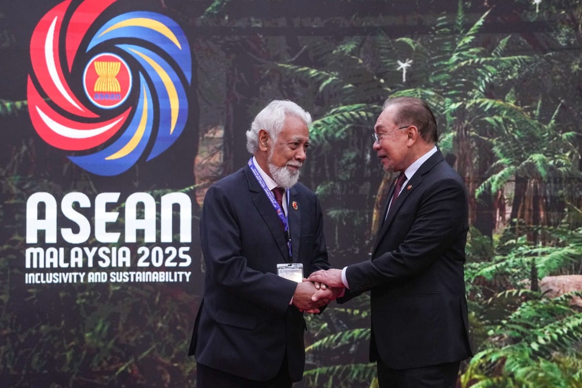 Malaysia's Prime Minister Anwar Ibrahim (R) greets East Timor's Prime Minister Xanana Gusmao as he arrives to attend the 47th Association of Southeast Asian Nations (ASEAN) Summit in Kuala Lumpur on October 26, 2025.