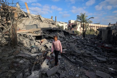A girl walks amid the rubble of a house destroyed in an Israeli strike in Nuseirat, in the central Gaza Strip, on October 29, 2025.