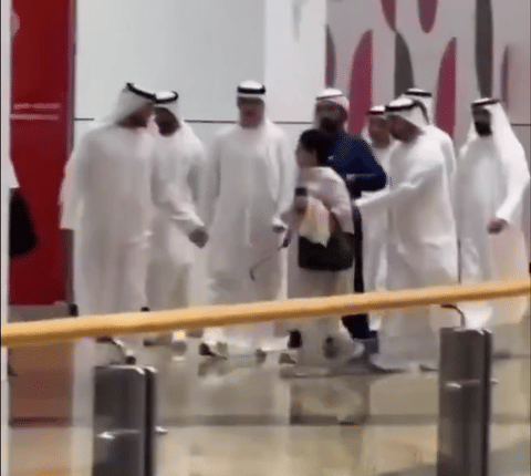 Short video clip shows Sheikh Mohammed walking with his security detail and a group of officials when a woman, seemingly unaware of his presence, crosses directly in front of him. 