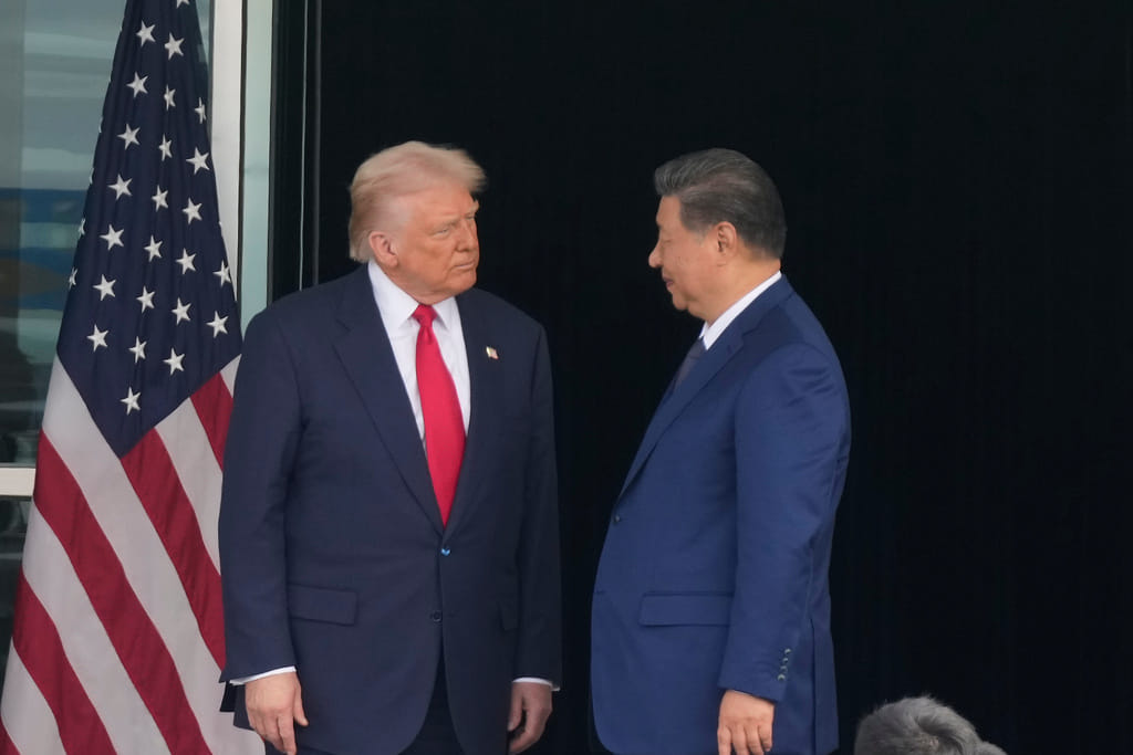 President Donald Trump, left, and Chinese President Xi Jinping, look at each other after their summit meeting at Gimhae International Airport Jinping in Busan, South Korea, Thursday, Oct. 30, 2025. (AP Photo/Mark Schiefelbein)