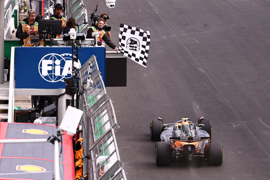 The checkered flag is waved as McLaren driver Lando Norris of Britain crosses the finish line to win the Brazilian Formula One Grand Prix at the Interlagos race track in Sao Paulo, Sunday, Nov. 9, 2025.