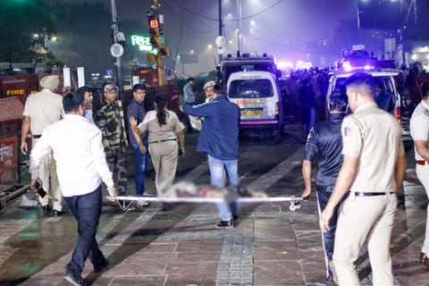 Injured individuals are being shifted by police personnel and ambulances from the site of a car blast near Gate No. 1 of the Red Fort Metro Station, in New Delhi, Monday, November 10, 2025
