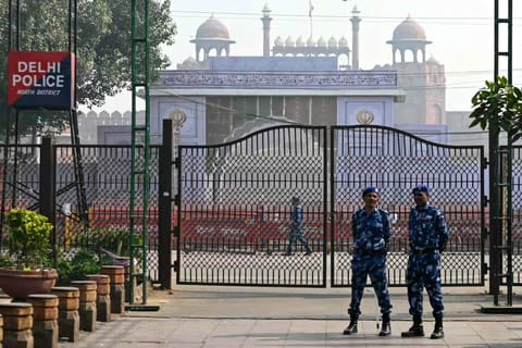 Rapid action force personnel stand guard near the blast site, after an explosion in the Red Fort area in the old quarters of Delhi, on November 12, 2025.