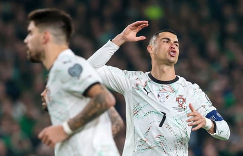 Portugal's forward Cristiano Ronaldo (R) reacts after missing a free kick during the men's football 2026 World Cup Group F qualifier between Ireland and Portugal at Aviva Stadium in Dublin on November 13, 2025.