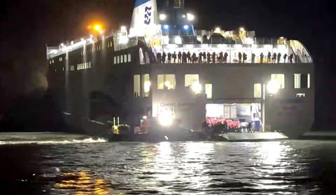 This handout photo taken on November 19, 2025 and released by the Mokpo Coast Guard via Yonhap shows the Coast Guard conducting rescue operations for passengers of the grounded ferry near Jangsan Island in Sinan County.