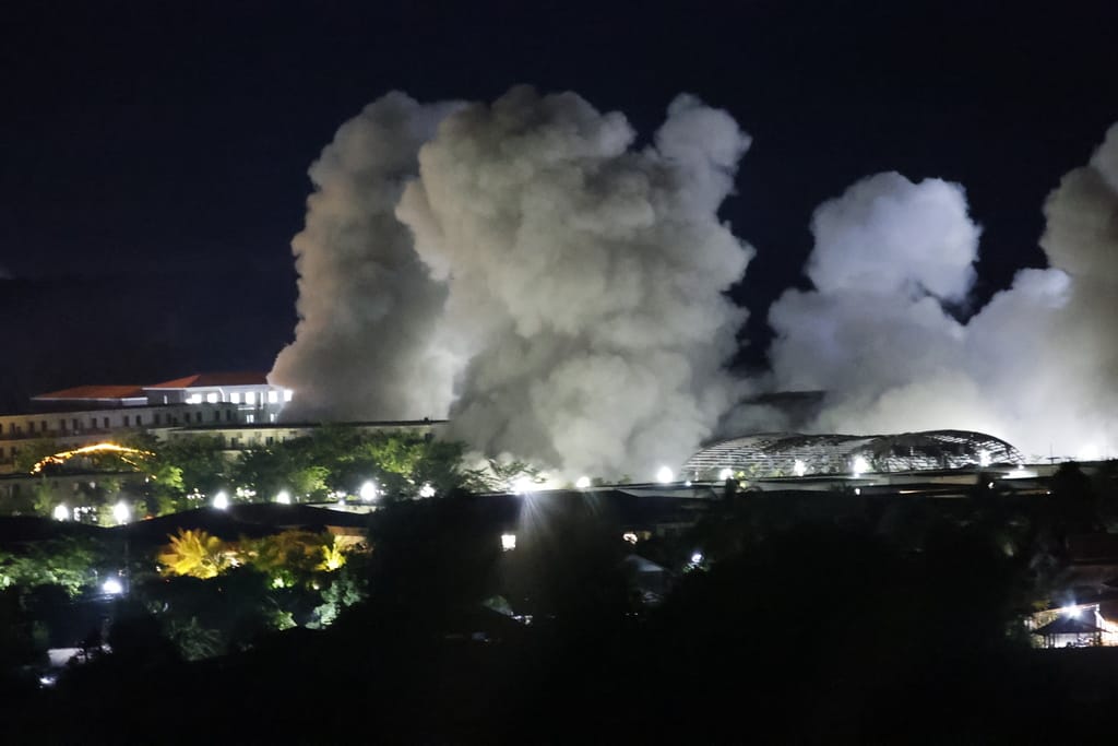 FILE - White smoke billows after an explosion at KK Park online scam center in Myawaddy township, Karen State, Myanmar, Saturday, Oct. 25, 2025. (AP Photo/Sarot Meksophawannakul, File)