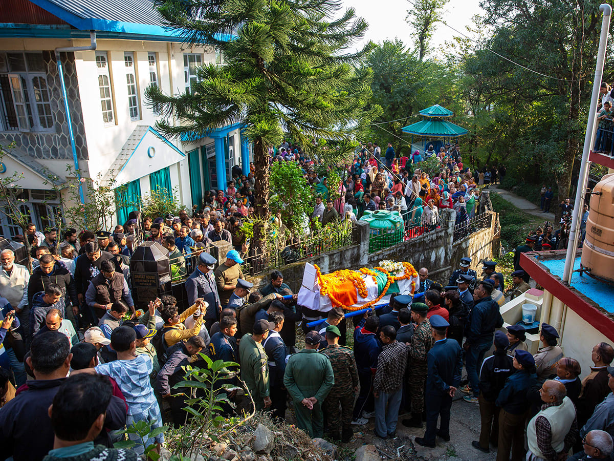 Indian Air Force personnel and relatives carry the casket containing the remains of Wing Commander Namansh Syal, who died in the Tejas plane crash at Dubai Airshow 2025 on Friday, for his final rites at his village near Dharamshala, India, on Sunday, November 23, 2025. 