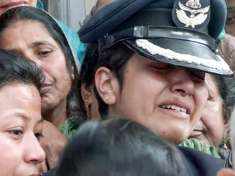 Indian Air Force personnel and relatives carry the casket containing the remains of Wing Commander Namansh Syal, who died in the Tejas plane crash at Dubai Airshow 2025 on Friday, for his final rites at his village near Dharamshala, India, on Sunday, November 23, 2025. 