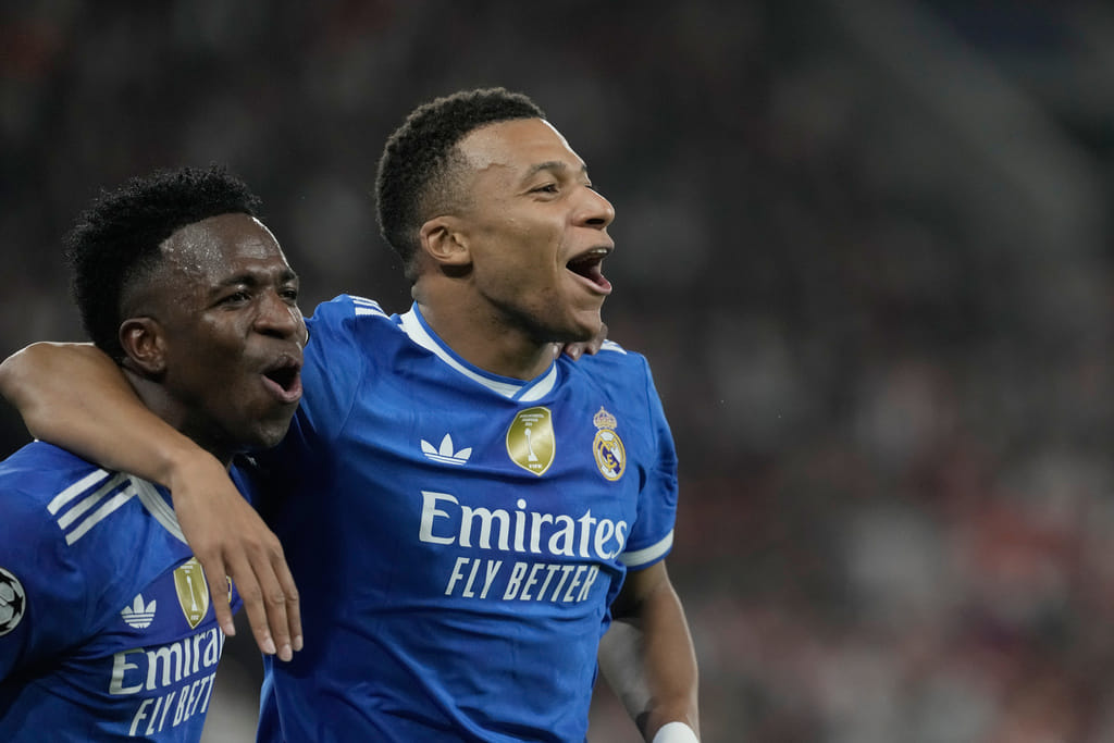 Real Madrid's Kylian Mbappe, right, celebrates with his teammate Vinicius Junior after scoring his side's fourth goal during the Champions League opening phase soccer match between Olympiacos and Real Madrid, in in Piraeus port, near Athens, Greece, Wednesday, Nov. 26, 2025.