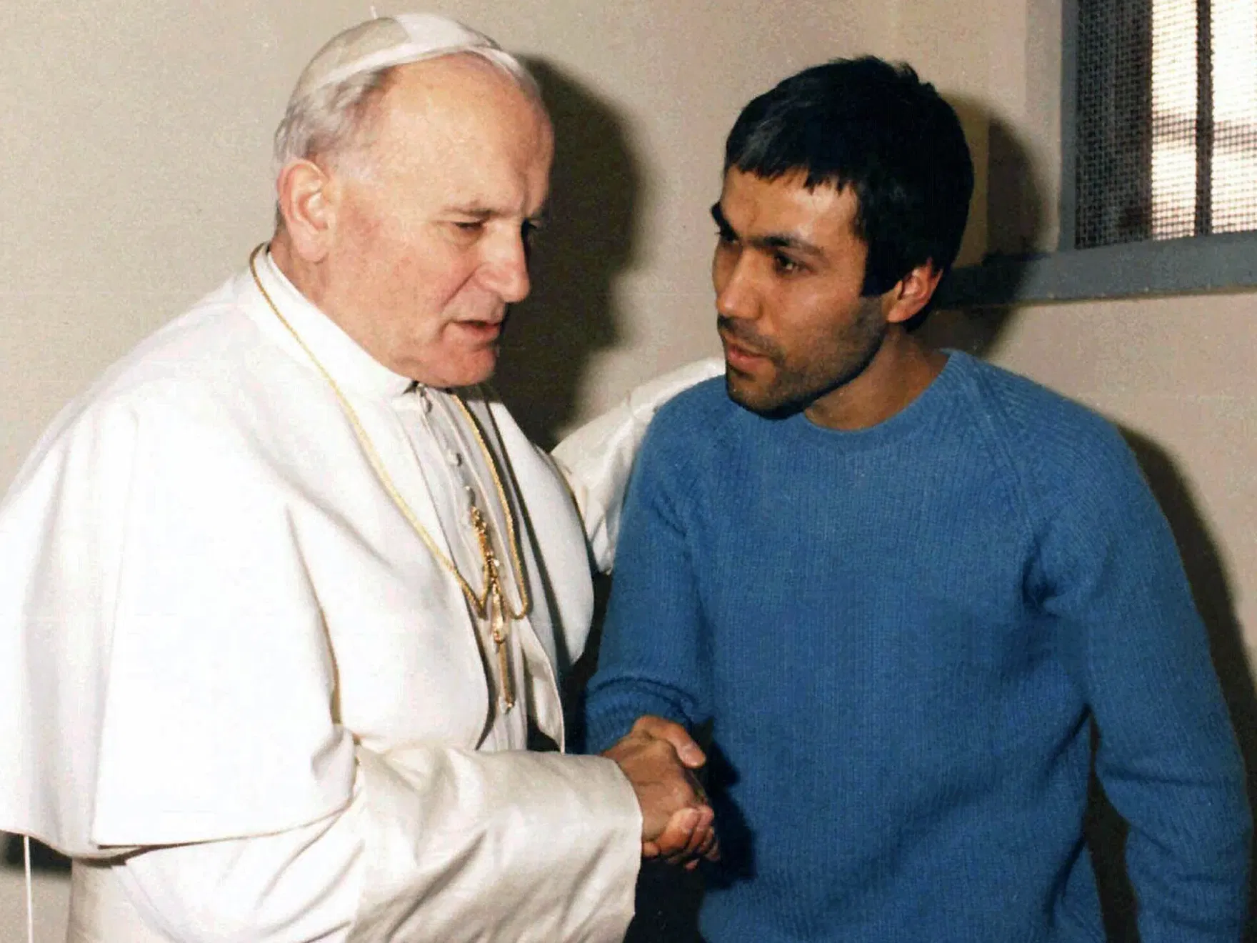 In a December 1983 file photo provided by Vatican newspaper L'Osservatore Romano, Pope John Paul II meets Mehmet Ali Agca, in Agca's prison cell in Rome.

