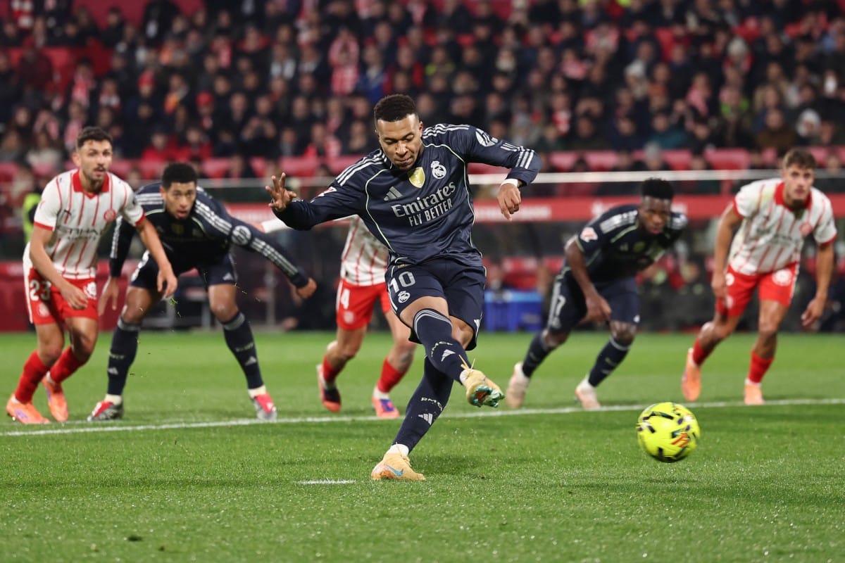Real Madrid's French forward Kylian Mbappe scores a goal from the penalty spot during the Spanish league football match against Girona FC at Montilivi Stadium in Girona on November 30, 2025.